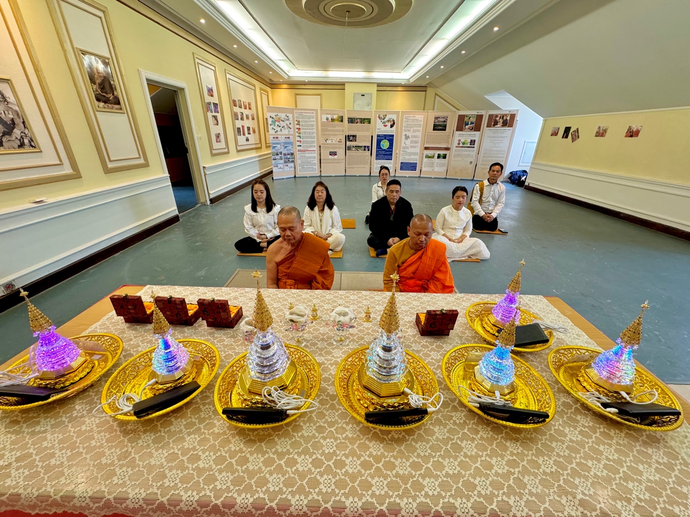 A group of people sitting on a table with plates of food
Description automatically generated